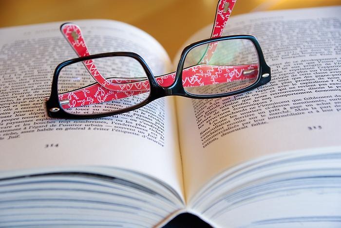 Bild på glasögon i en uppslagen bok